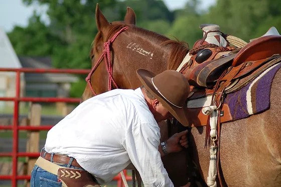 Preparing a horse and saddle at Freedom Ranch
